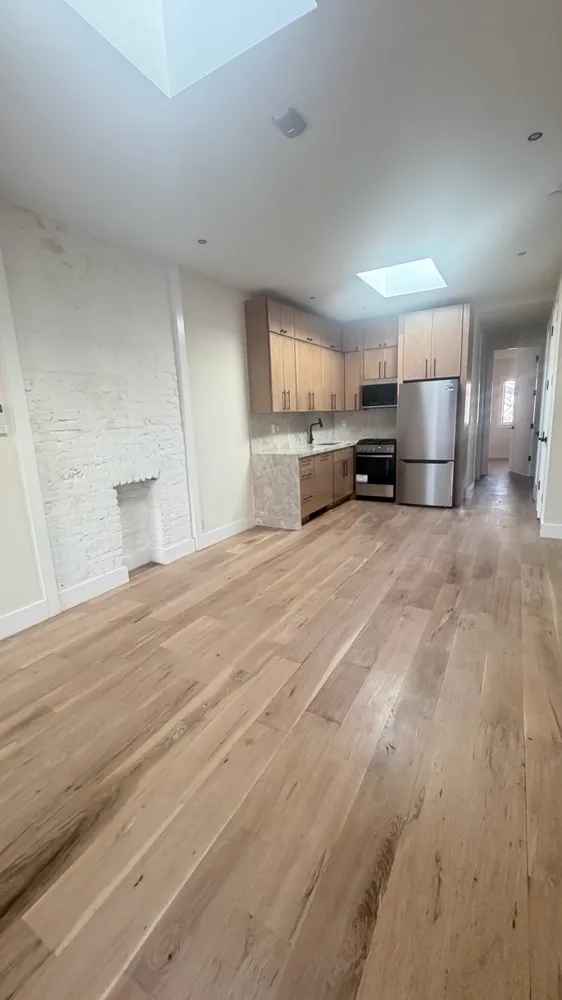 a large kitchen with a large window in it and a kitchen island