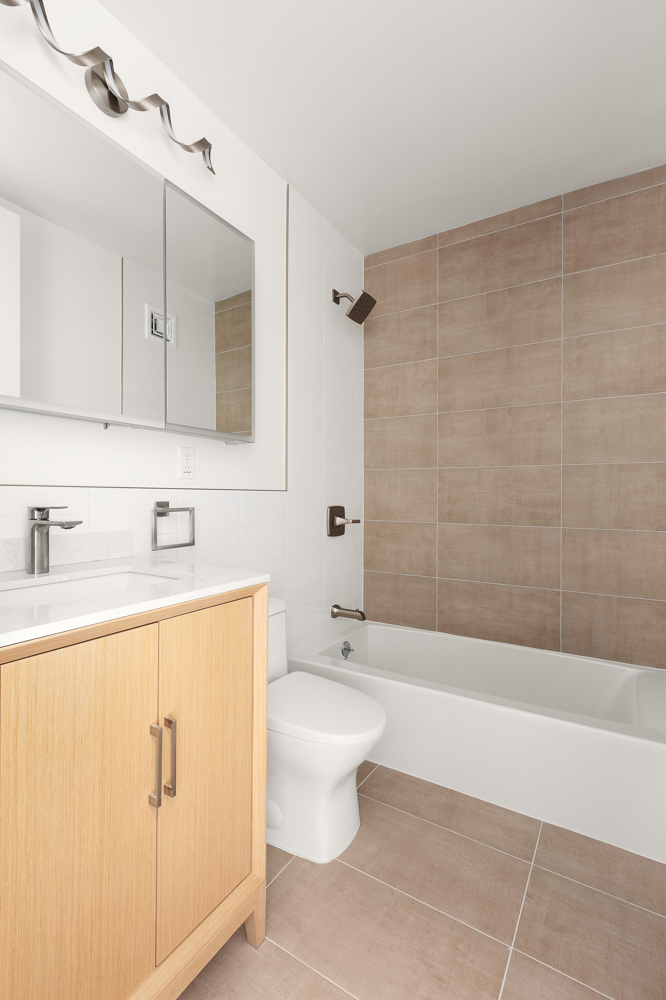 161 West 61st Street, Unit 5C Manhattan, NY 10023 - Photo 18 of 30 a bathroom with a sink a toilet and shower