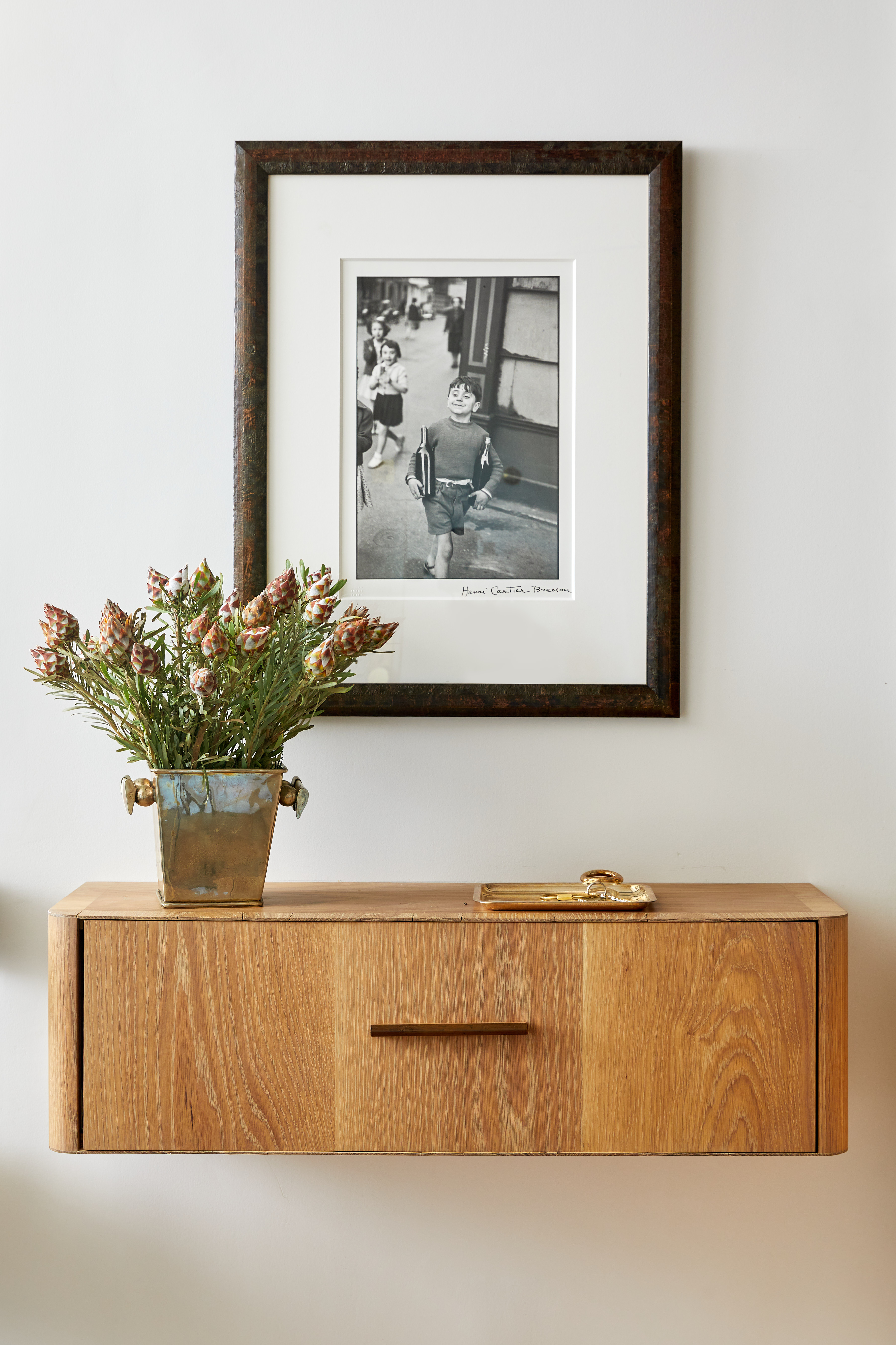 30 5th Avenue, Unit 16H Manhattan, NY 10011 - Photo 11 of 15 a view of a room with a wall clock and a potted plant