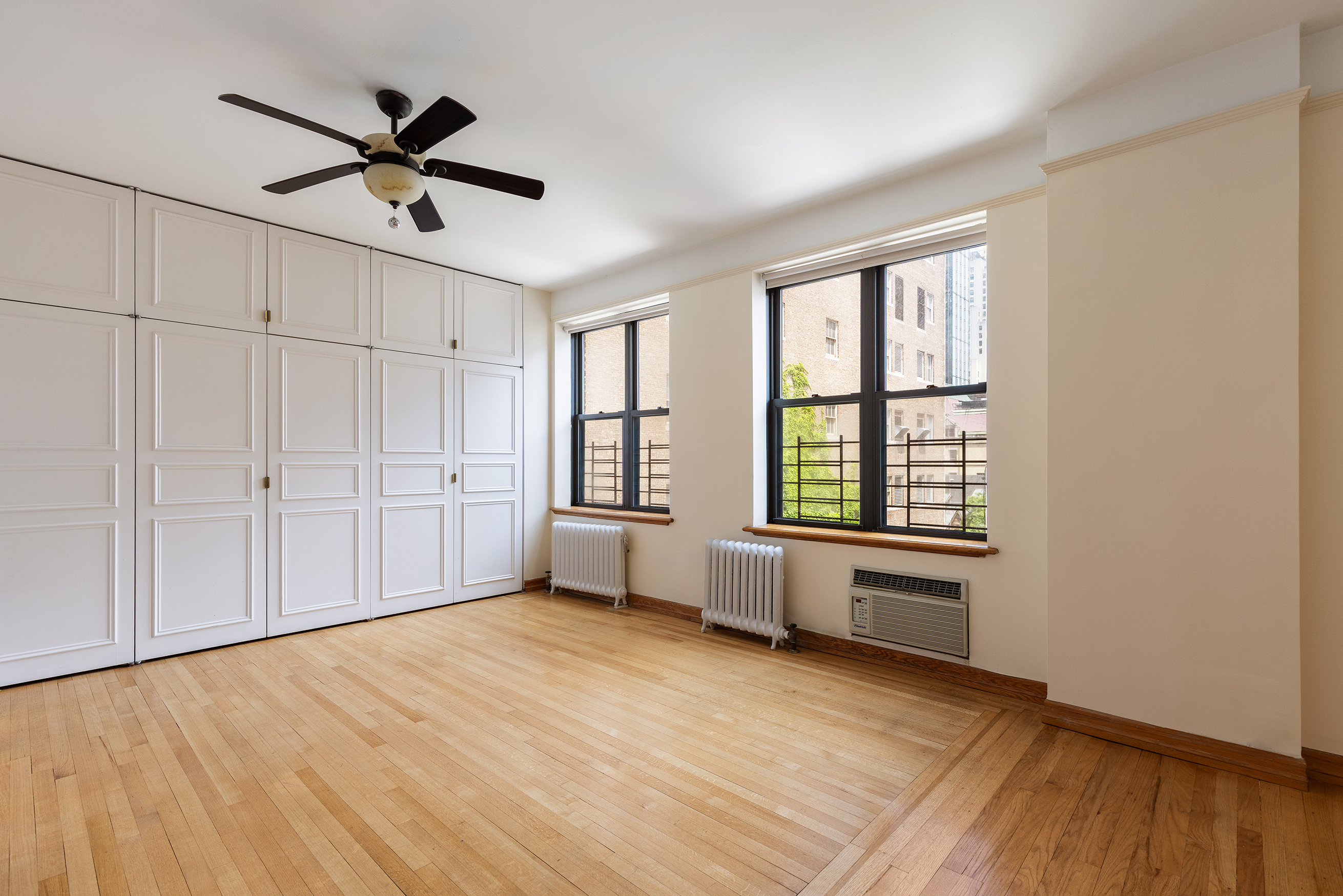 7 Gramercy Park West, Unit 6AB Manhattan, NY 10003 - Photo 4 of 12 a view of empty room with wooden floor and fan
