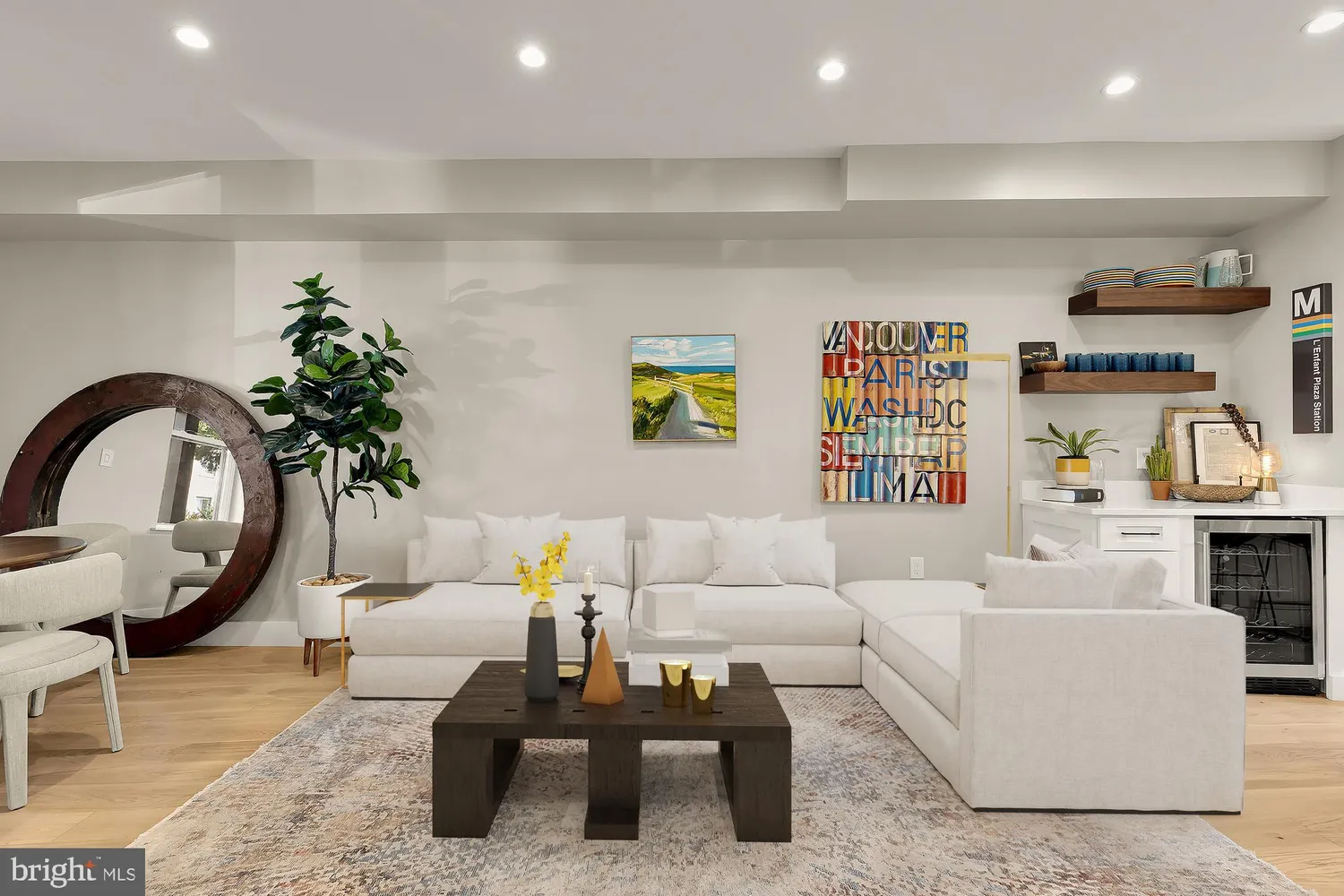 a living room with furniture a rug and potted plant