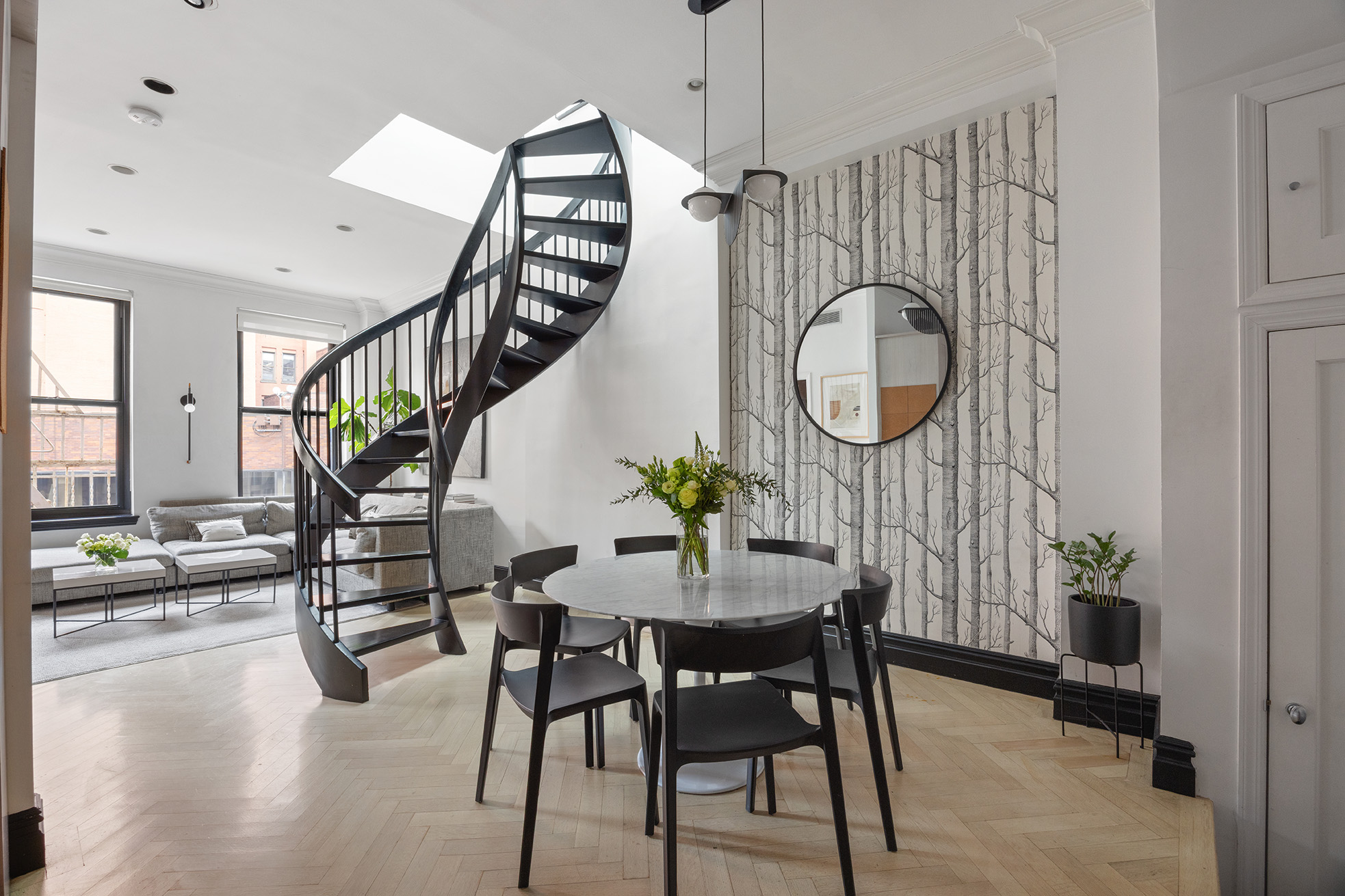 250 Mercer Street, Unit A504 Manhattan, NY 10012 - Photo 3 of 13 a dining room with furniture a rug and a chandelier
