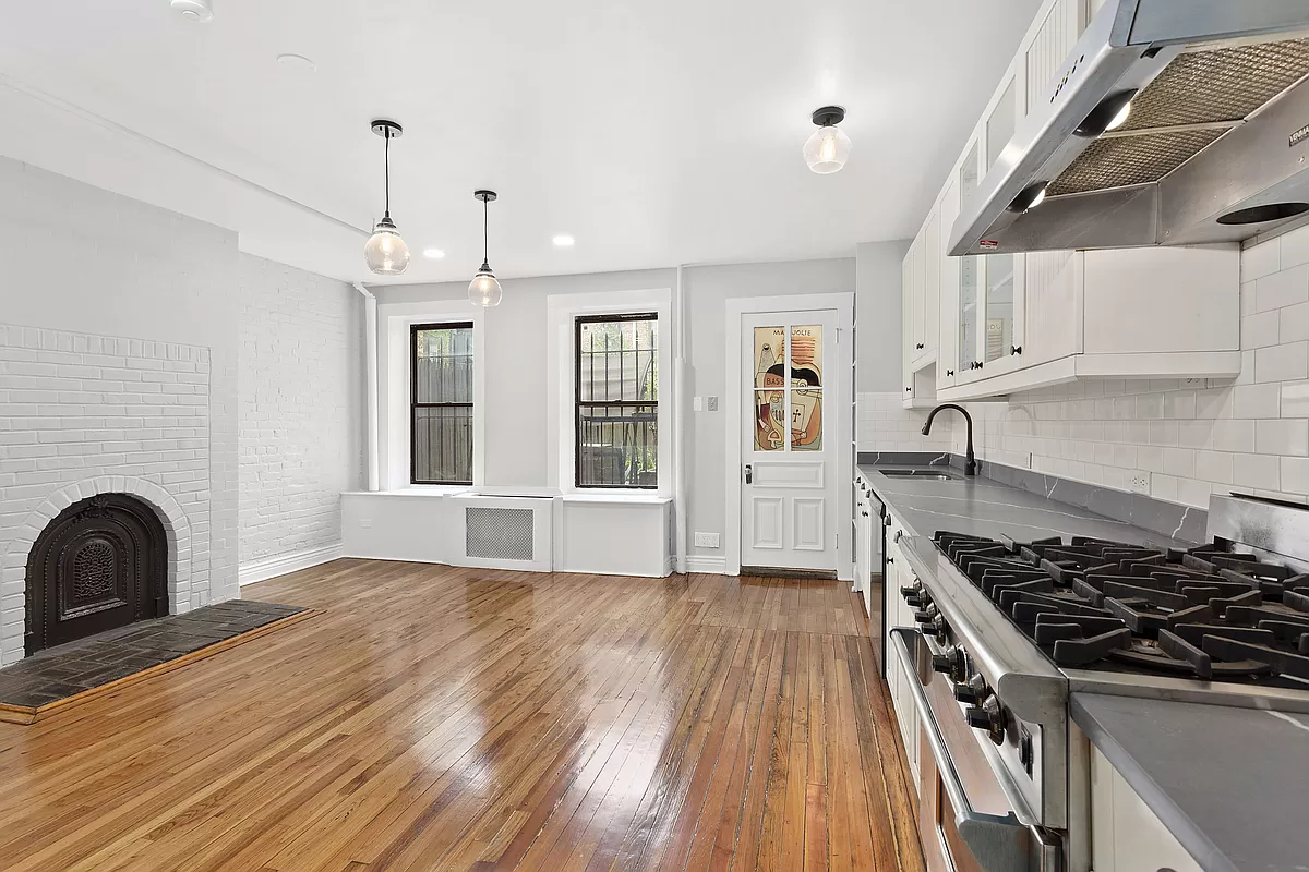 7 West 122nd Street Manhattan, NY 10027 - Photo 4 of 23 a kitchen with granite countertop a stove and a wooden floors