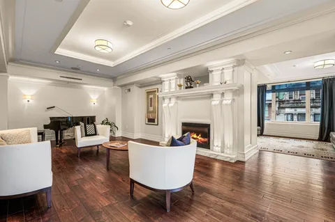 a view of a livingroom with kitchen and dining table