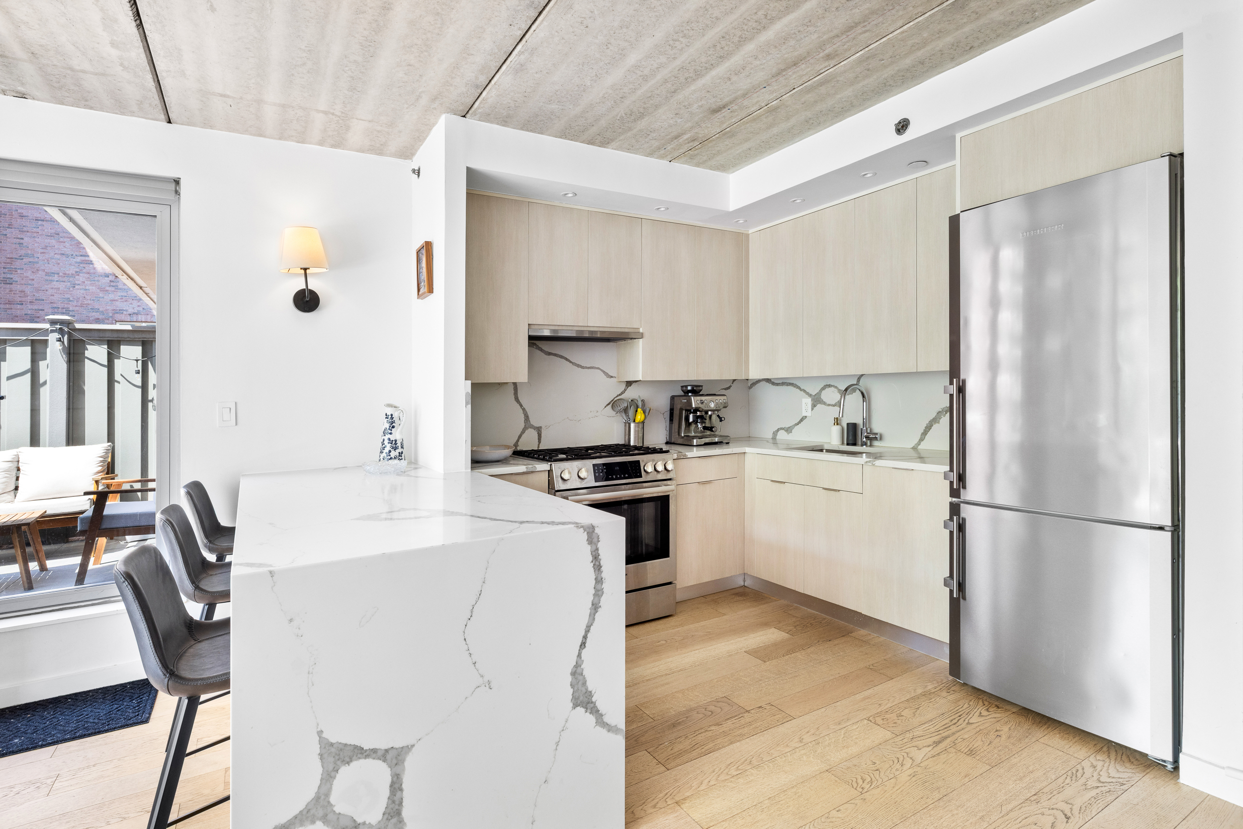 192 Spencer Street, Unit 3A Brooklyn, NY 11205 - Photo 3 of 12 a kitchen with white cabinets and white appliances