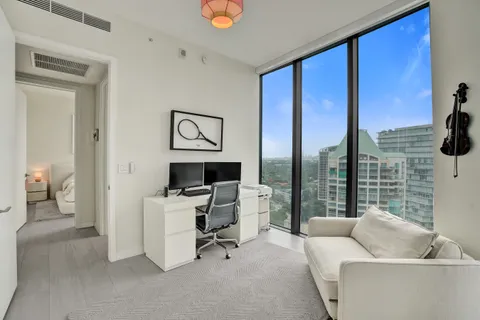 a living room with furniture and a floor to ceiling window