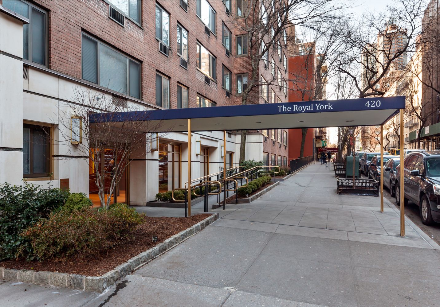 420 East 64th Street, Unit E10J Manhattan, NY 10065 - Photo 5 of 6 a couple of cars parked in front of brick building