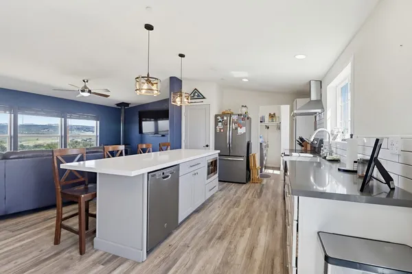 a view of a room with furniture and wooden floor
