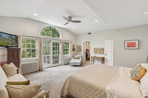 a bedroom with a large bed and a large window