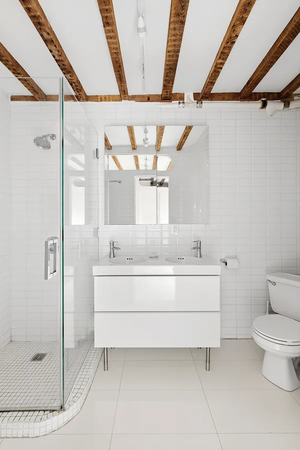 a bathroom with a sink mirror vanity and toilet