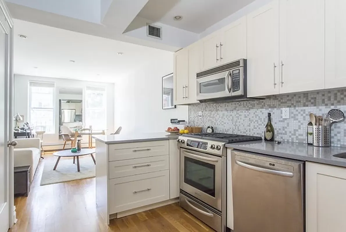 356 12th Street, Unit 2A Brooklyn, NY 11215 - Photo 2 of 7 a kitchen with granite countertop cabinets stainless steel appliances and wooden floor