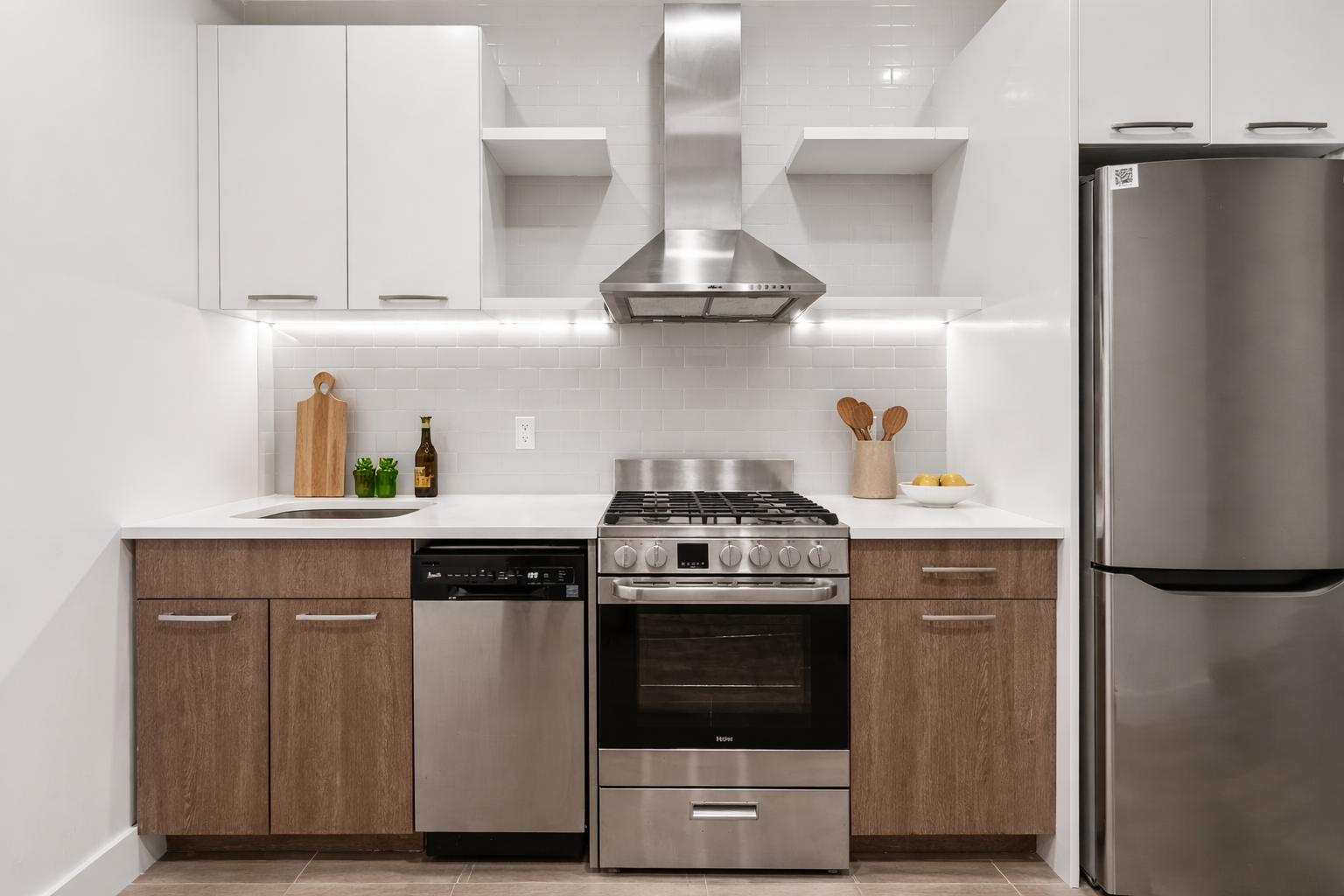 911 Nostrand Avenue, Unit 1R Brooklyn, NY 11225 - Photo 3 of 13 a kitchen with stainless steel appliances granite countertop a stove a refrigerator and a microwave