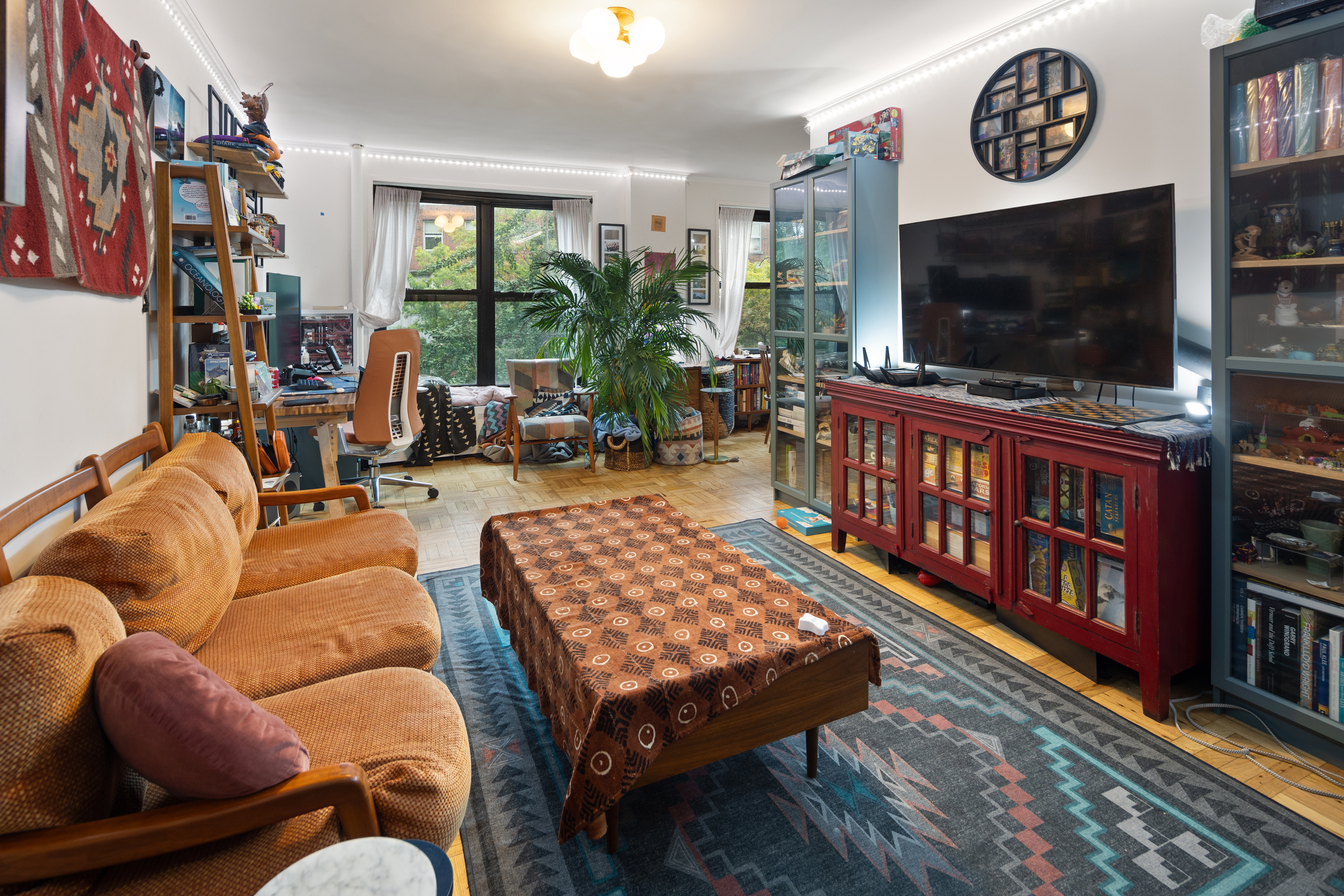 210 Clinton Avenue, Unit 4B Brooklyn, NY 11205 - Photo 2 of 8 a living room with furniture and a flat screen tv