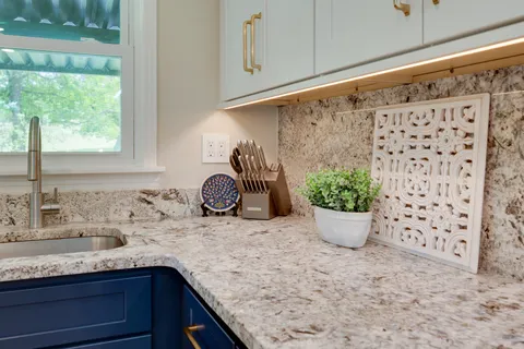 a kitchen with granite countertop a sink and cabinets