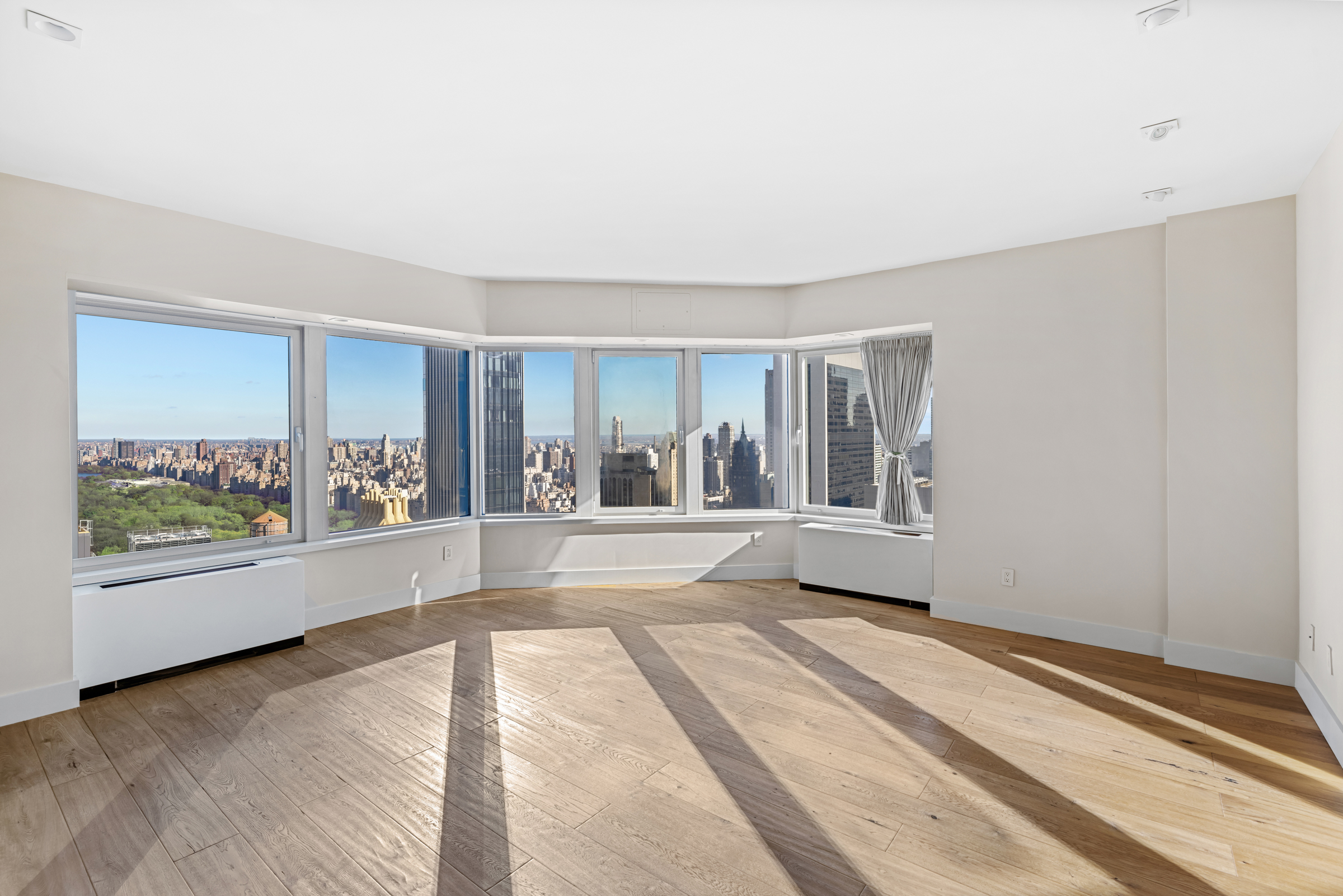 150 West 56th Street, Unit 4802 Manhattan, NY 10019 - Photo 6 of 13 a view of a room with window and hardwood