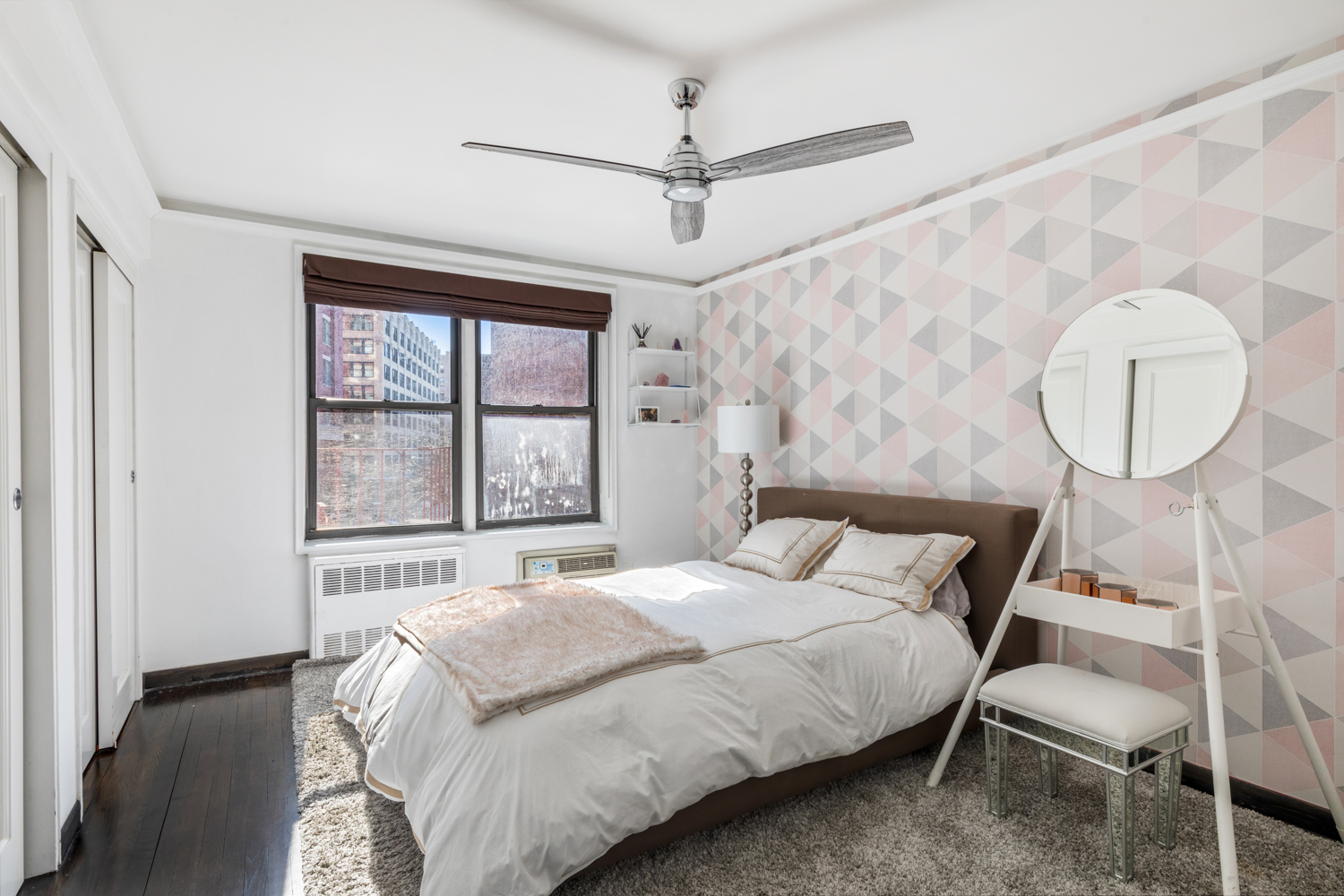 165 Christopher Street, Unit 3I Manhattan, NY 10014 - Photo 9 of 20 a bedroom with a bed mirror and window