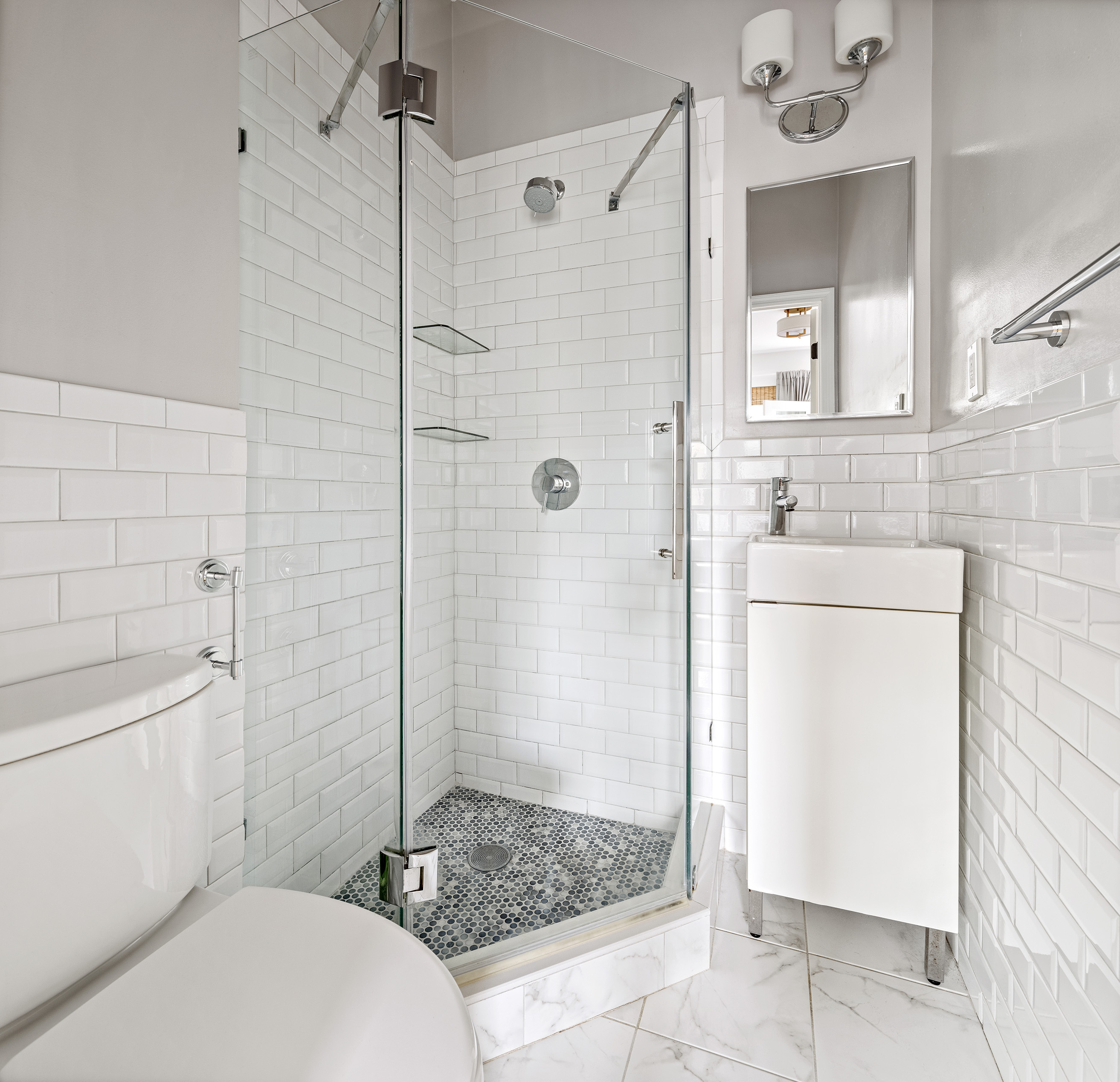 454 12th Street, Unit 3 Brooklyn, NY 11215 - Photo 9 of 18 a bathroom with a shower a mirror and a toilet