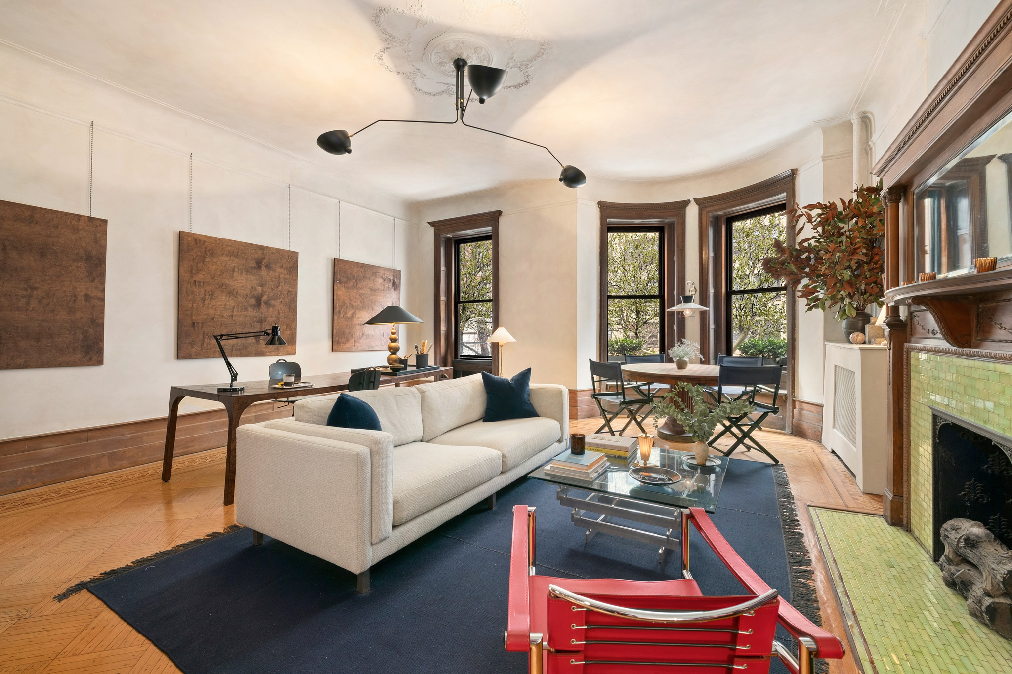 309 West 103rd Street, Unit 3 Manhattan, NY 10025 - Photo 3 of 9 a living room with furniture a flat screen tv and a fireplace