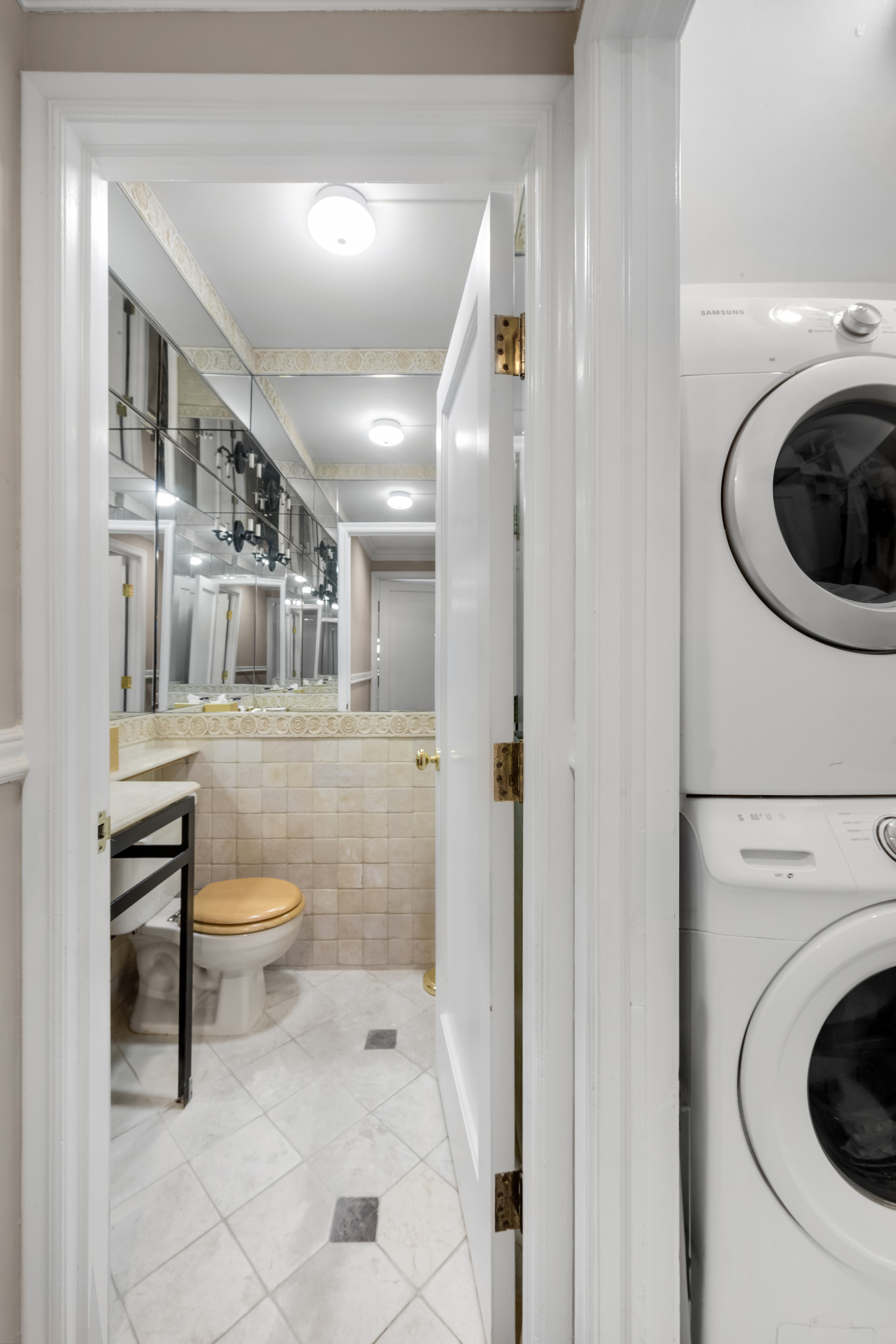 27 East 65th Street, Unit 10BC Manhattan, NY 10065 - Photo 14 of 16 a bathroom with a toilet sink and mirror