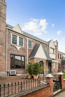 a view of a brick house with many windows