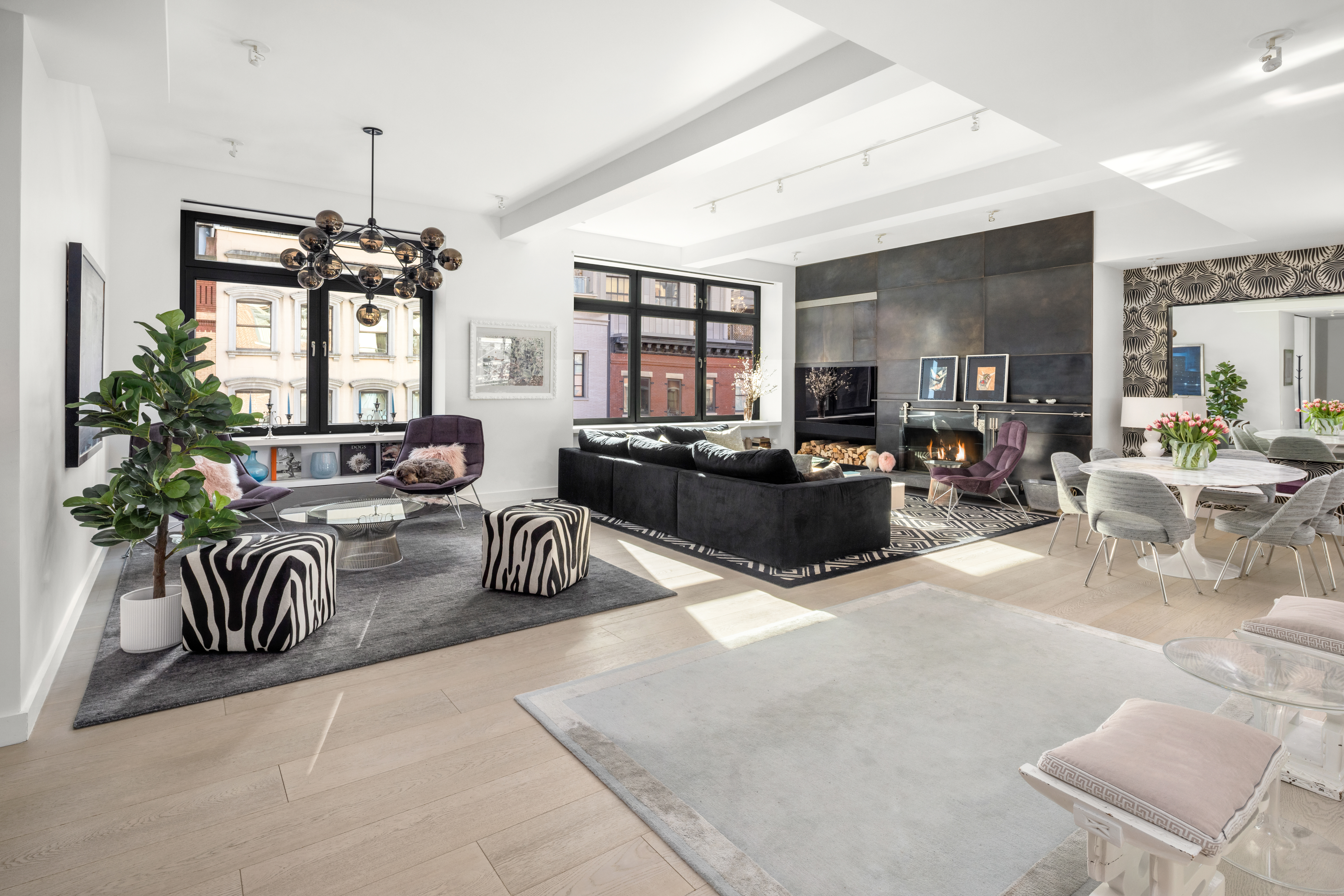 a living room with furniture fireplace and a large window