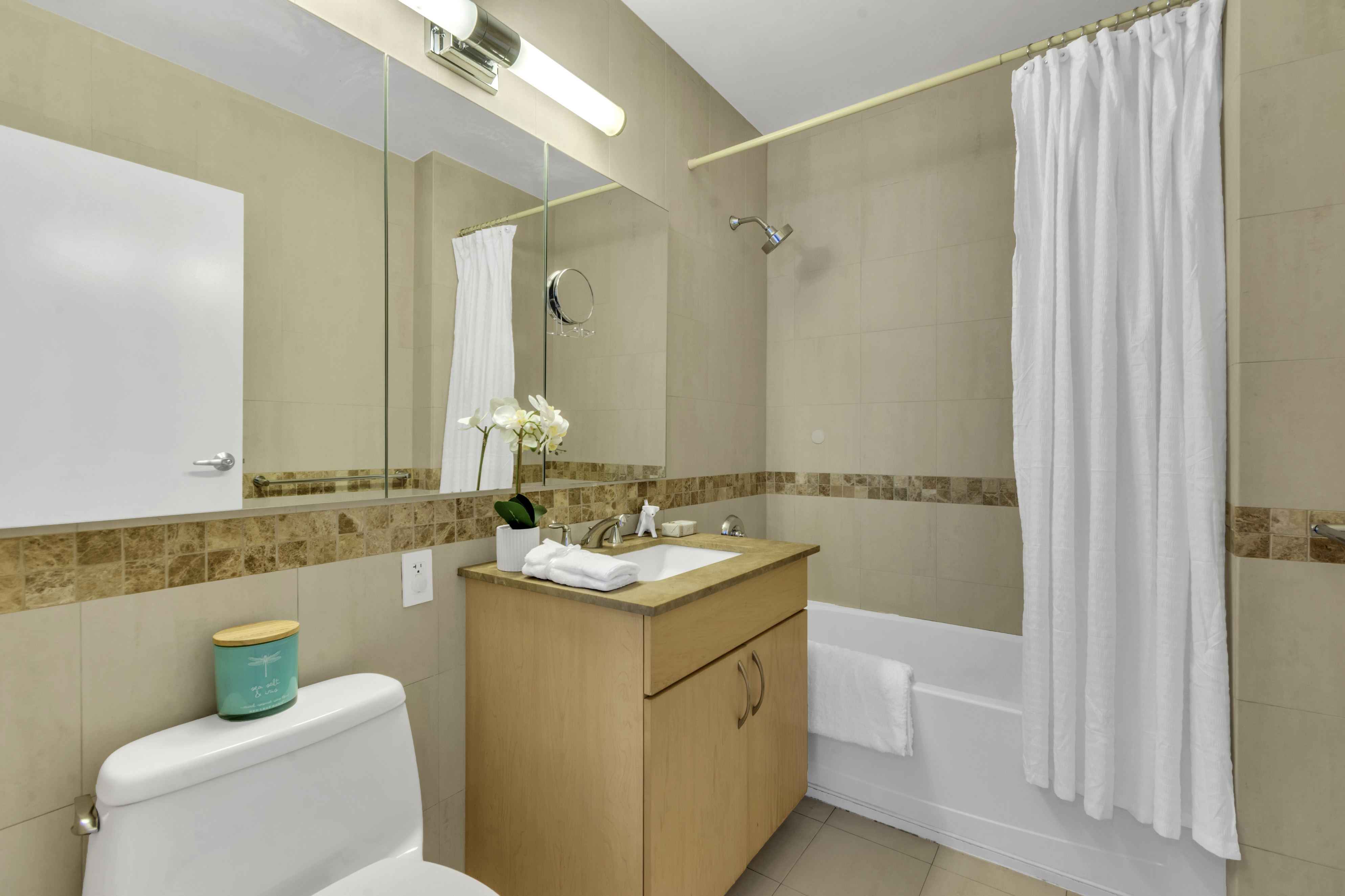 40 West 116th Street, Unit A907 Manhattan, NY 10026 - Photo 10 of 34 a bathroom with a sink and a mirror