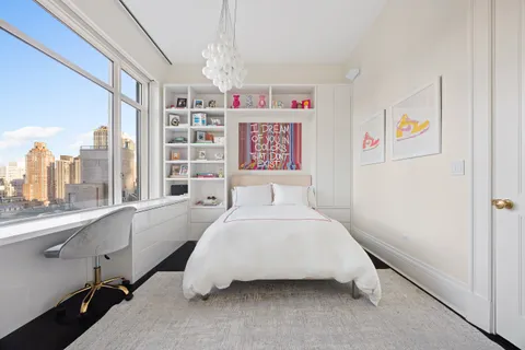 a bedroom with a bed and a large window