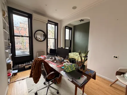 a bedroom with a bed and a window