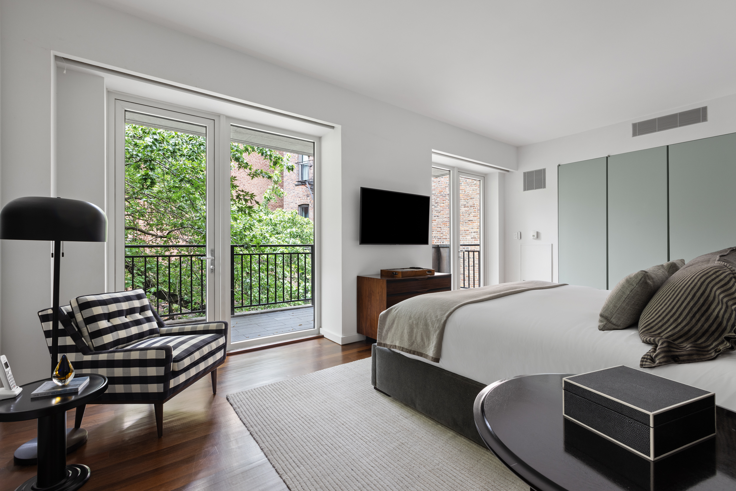 744 Greenwich Street, Unit 4 Manhattan, NY 10014 - Photo 22 of 34 a bedroom with a bed and a flat screen television