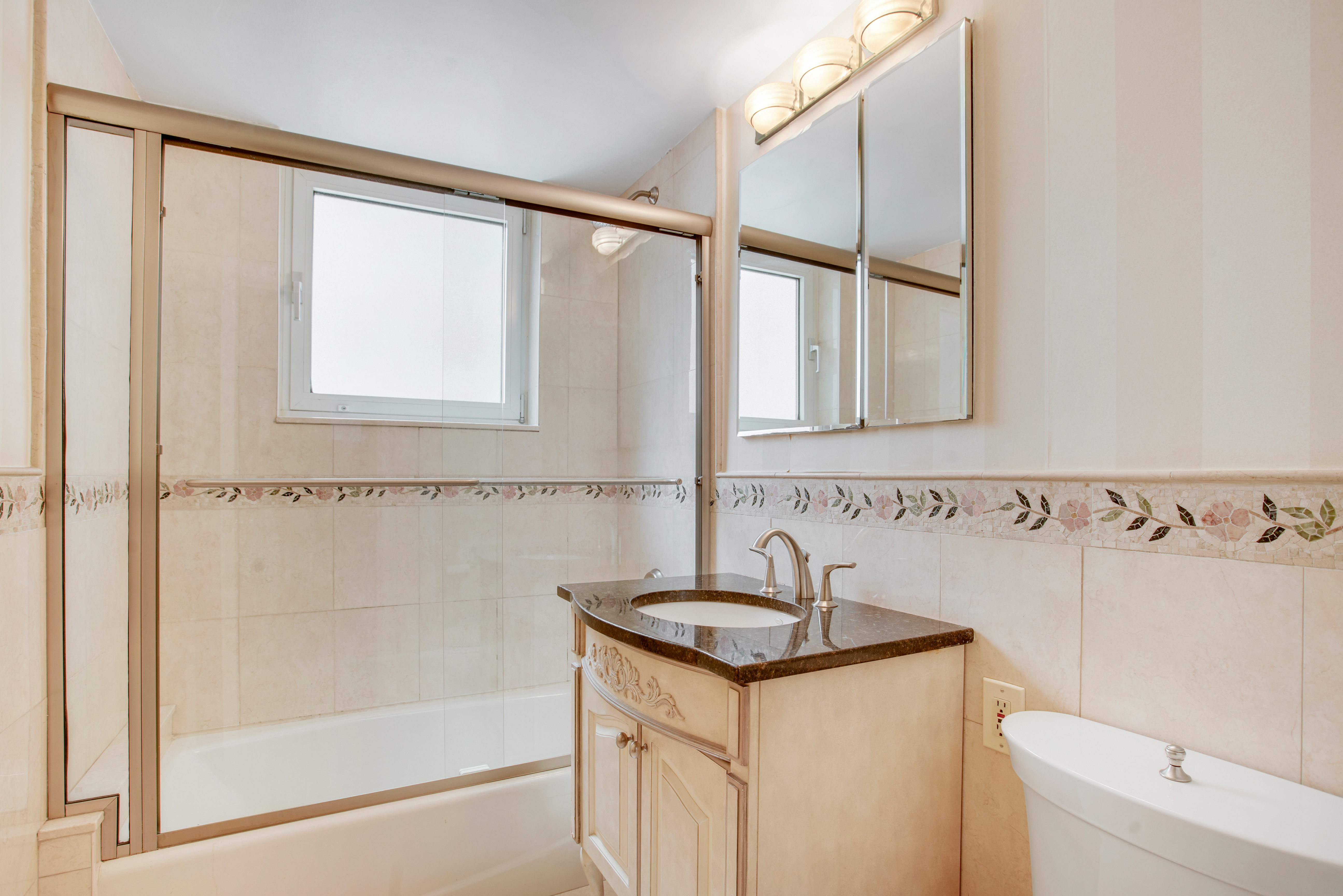 45 Sutton Place South, Unit 9O Manhattan, NY 10022 - Photo 9 of 16 a bathroom with a sink and a mirror