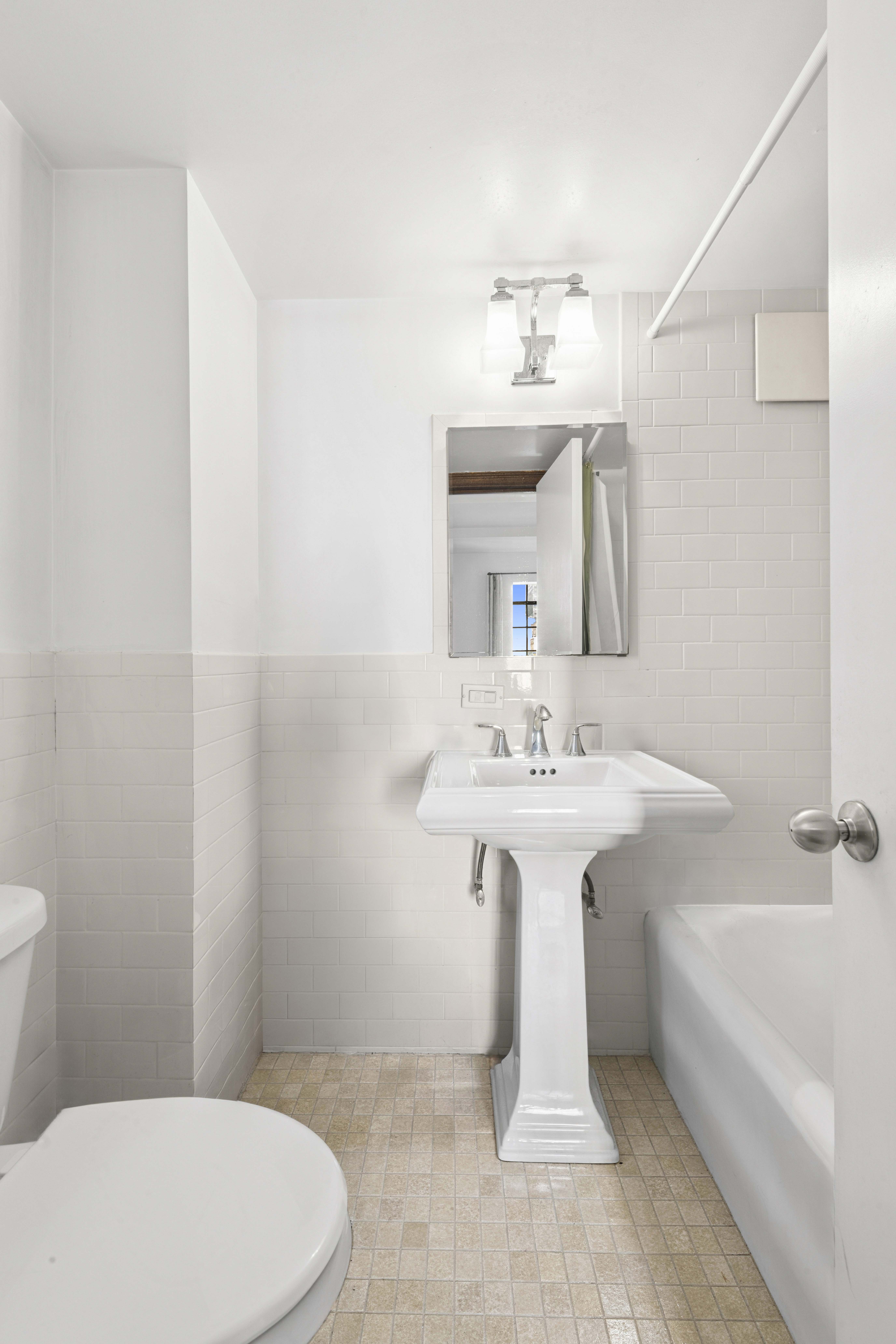 25 Tudor City Place, Unit 1611 Manhattan, NY 10017 - Photo 5 of 15 a bathroom with a sink a toilet and shower