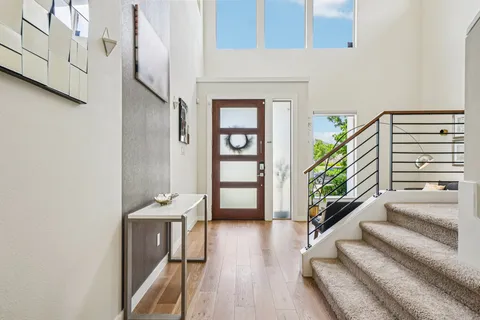 a view of a hallway with furniture and a potted plant