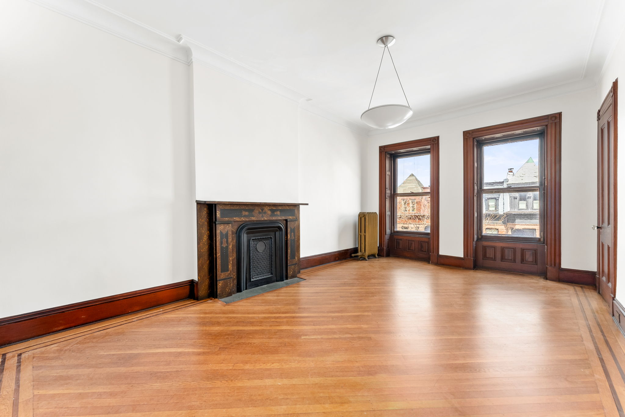 694 10th Street, Unit 2 Brooklyn, NY 11215 - Photo 12 of 22 a view of an empty room with window and wooden floor