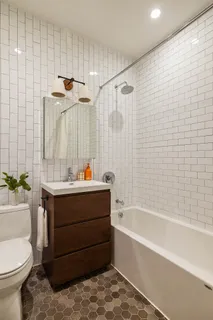 a bathroom with a bathtub shower sink and toilet