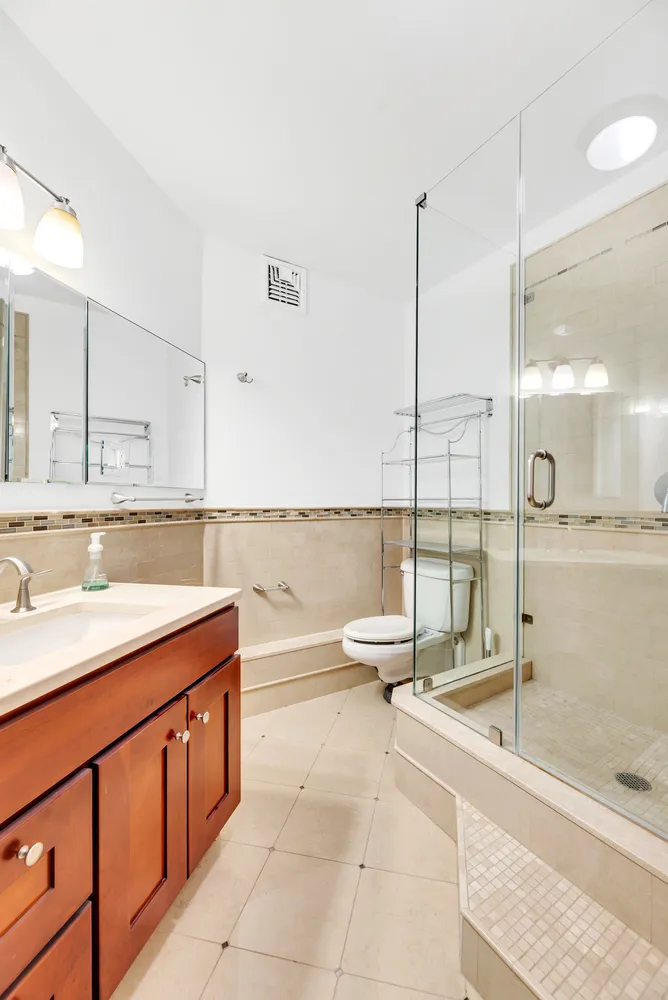 a bathroom with a tub sink and mirror