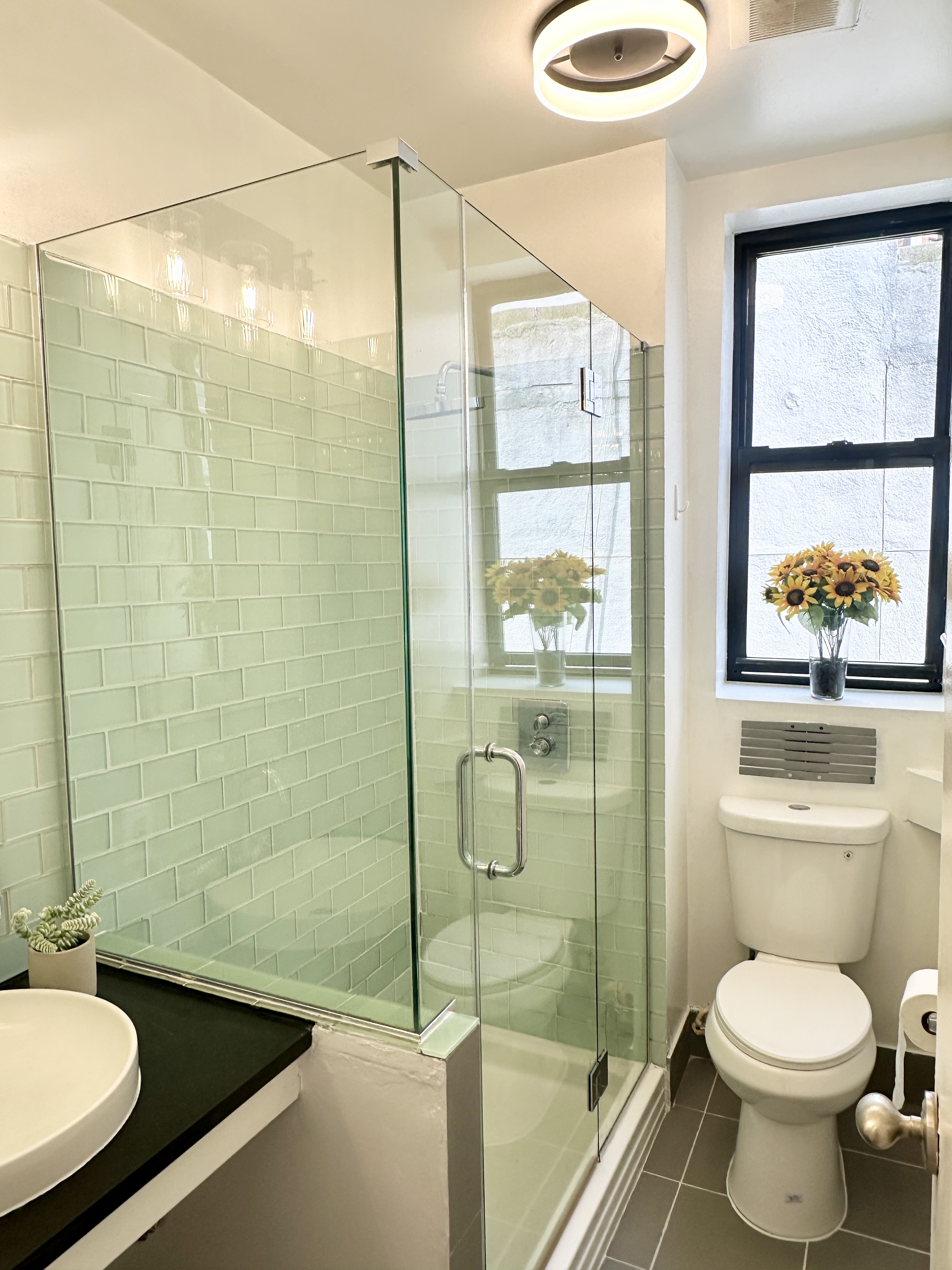 246 East 51st Street, Unit 22 Manhattan, NY 10022 - Photo 6 of 9 a bathroom with a sink toilet and shower