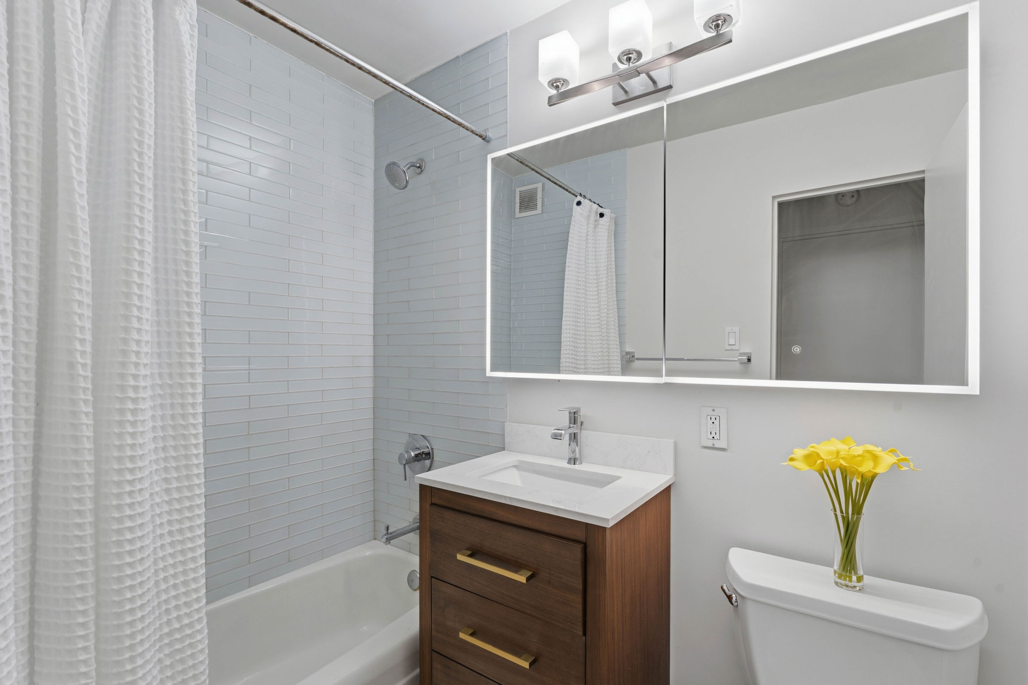 245 East 87th Street, Unit 17C Manhattan, NY 10128 - Photo 8 of 11 a bathroom with a sink a toilet and shower