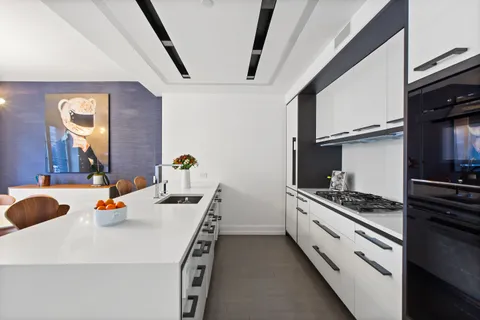 a kitchen with a sink and stove top oven