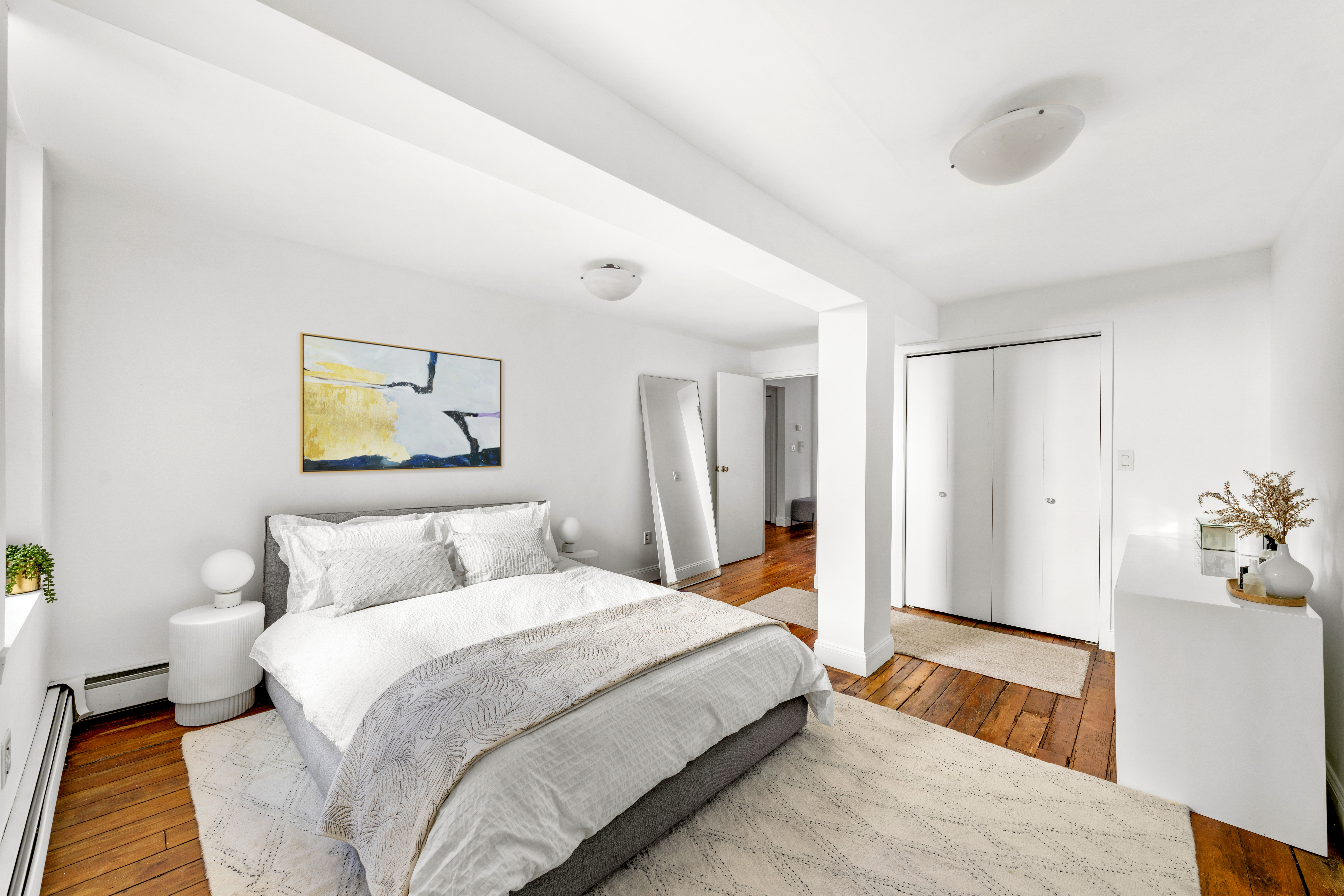 24 Harrison Street, Unit 3 Manhattan, NY 10013 - Photo 6 of 11 a bedroom with a large bed and a chandelier