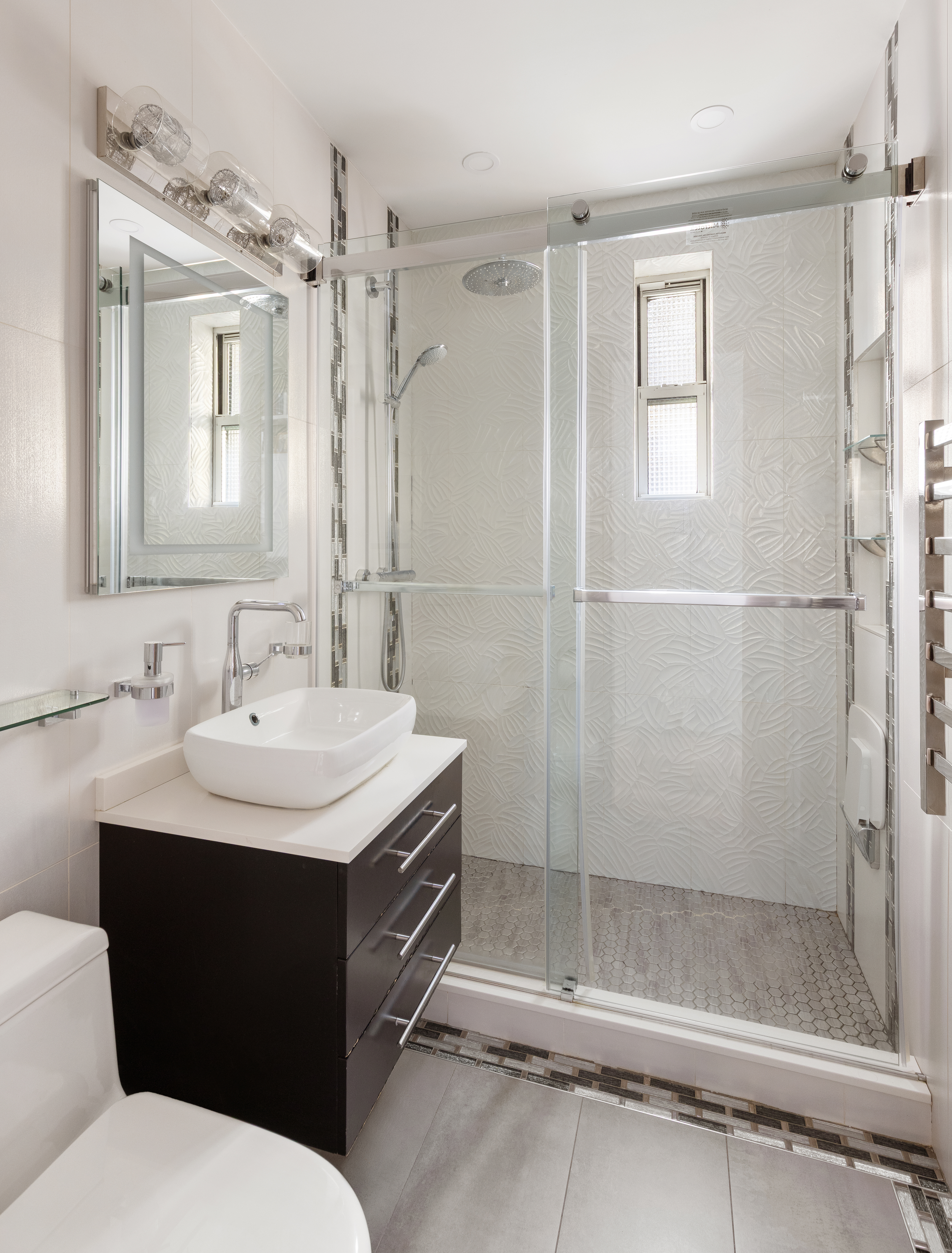 59 Pineapple Street, Unit 3F Brooklyn, NY 11201 - Photo 6 of 8 a bathroom with a sink toilet and shower