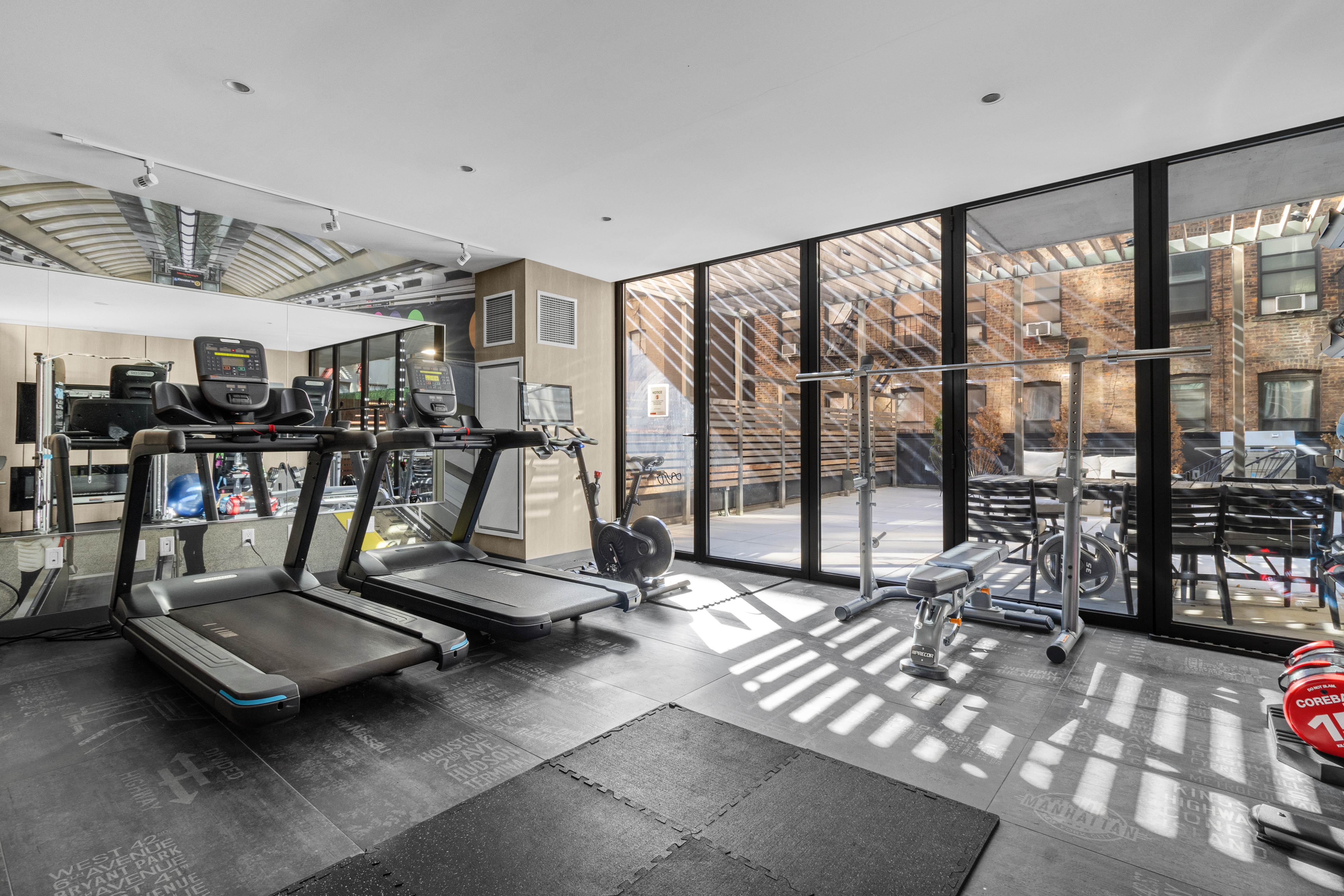 302 East 96th Street, Unit 1103 Manhattan, NY 10128 - Photo 17 of 22 a view of a room with gym equipment