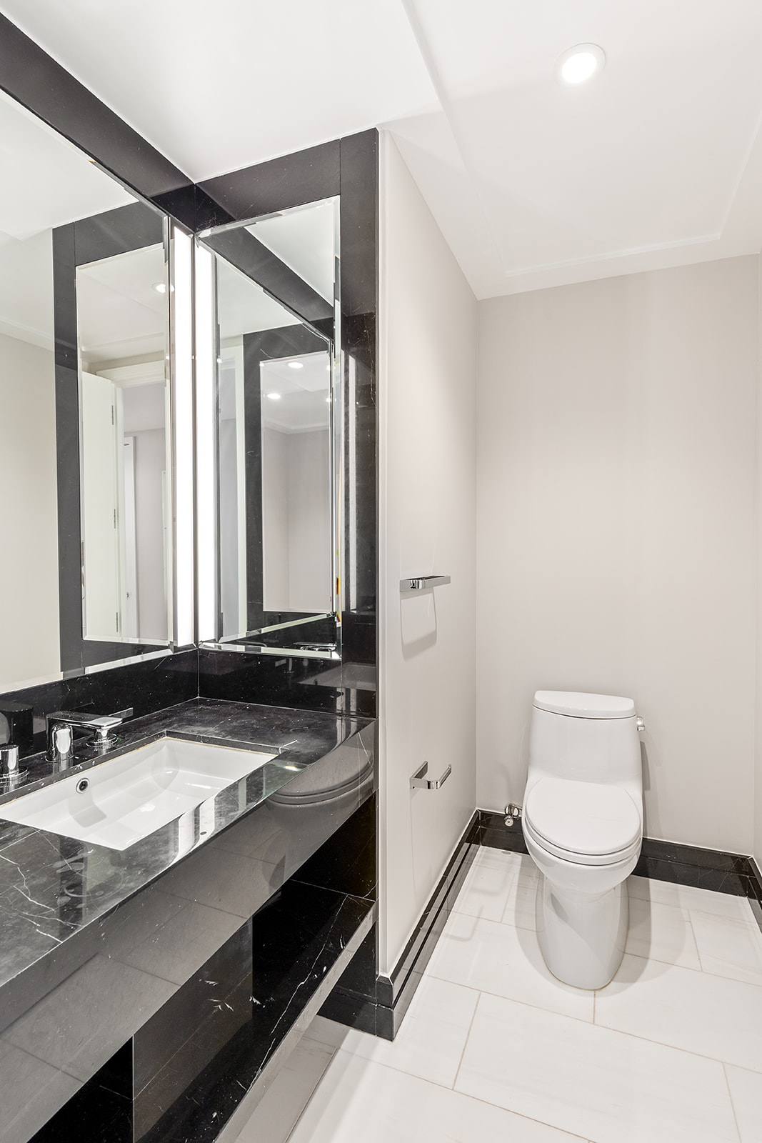 10 Riverside Boulevard, Unit 30B Manhattan, NY 10069 - Photo 10 of 19 a bathroom with a granite countertop sink a toilet and a mirror