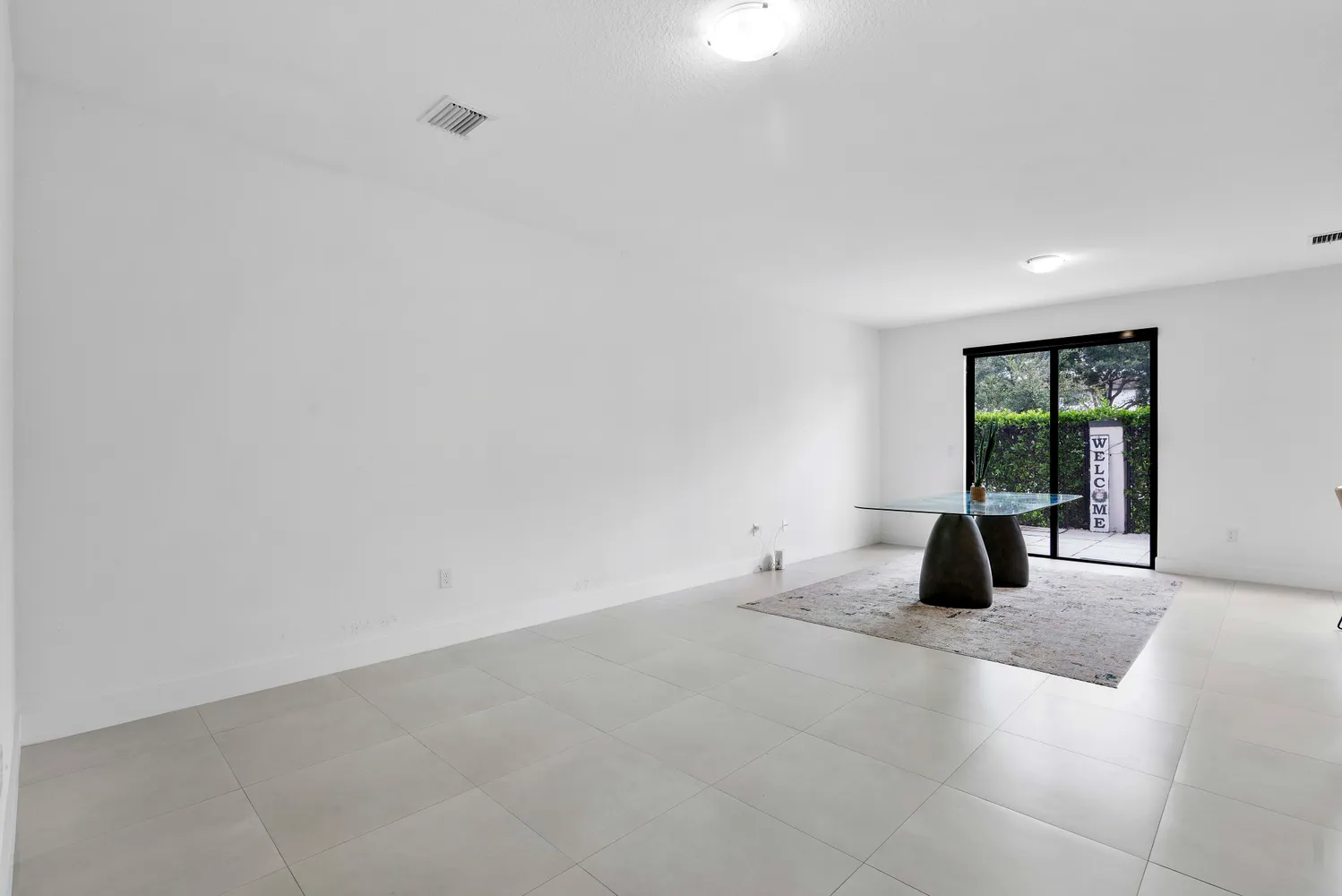 a large white bed sitting in a room next to a window