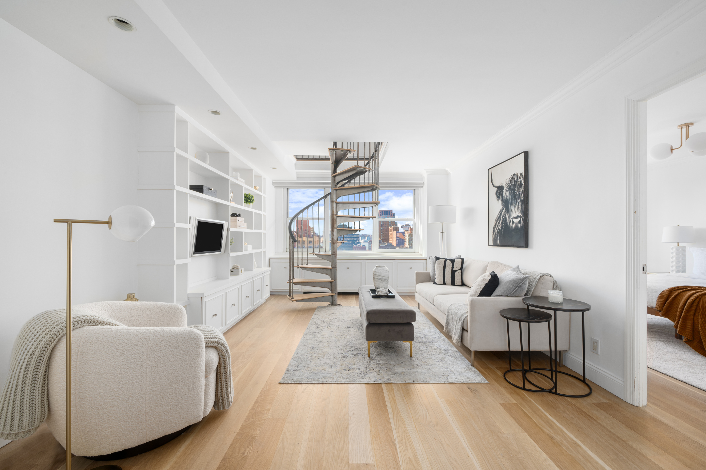 360 West 22nd Street, Unit 15C-14C Manhattan, NY 10011 - Photo 9 of 16 a living room with furniture and a large window