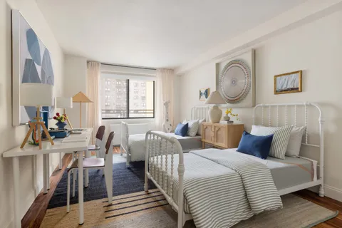 a bedroom with furniture and wooden floor