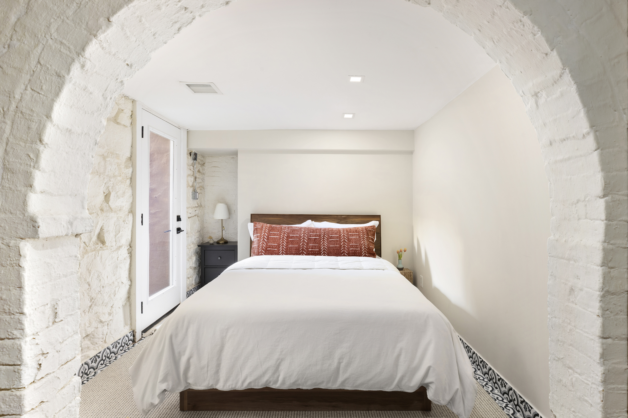 437 Putnam Avenue, Unit 1 Brooklyn, NY 11221 - Photo 4 of 12 a bedroom with a bed and a white wall painting