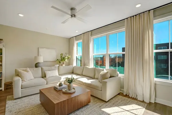 a living room with furniture and a large window
