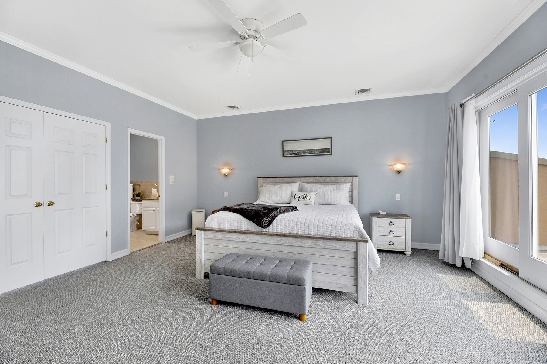 102-20 Rockaway Beach Boulevard, Unit 3C Queens, NY 11694 - Photo 24 of 36 a bedroom with a bed and a chandelier
