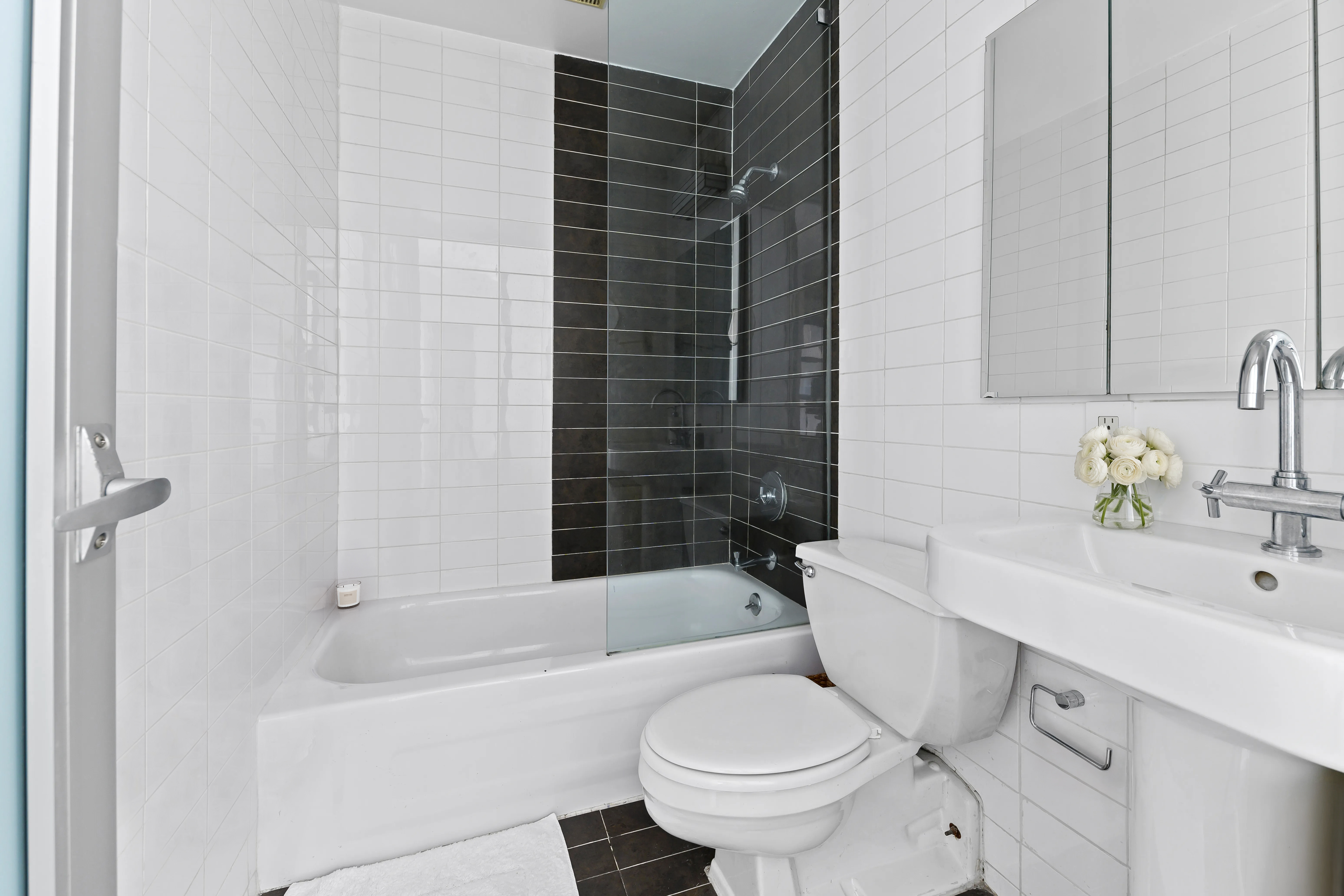 4 Lexington Avenue, Unit 8J Manhattan, NY 10010 - Photo 4 of 8 a bathroom with a sink toilet and shower