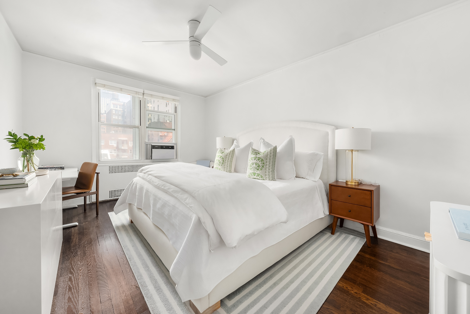 166 West 22nd Street, Unit 6C Manhattan, NY 10011 - Photo 4 of 11 a bed room with a bed and a chair